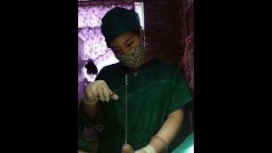 Chinese Doctor doing Sounding Wearing Tight Surgical Gloves